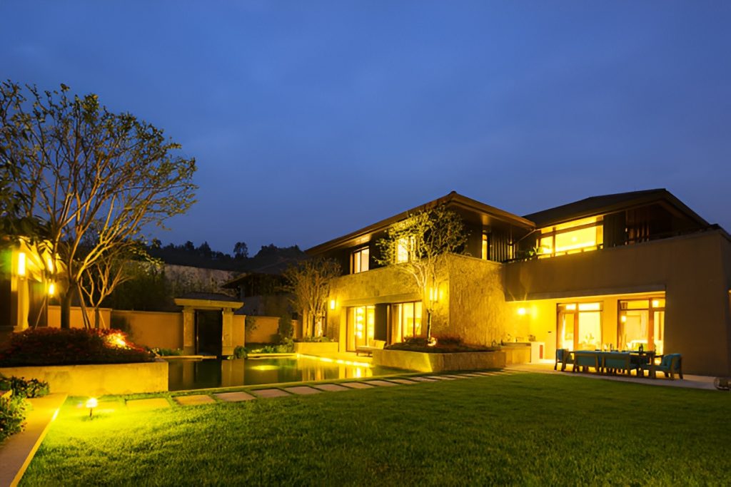 well-lit outdoor space featuring a patio and a swimming pool